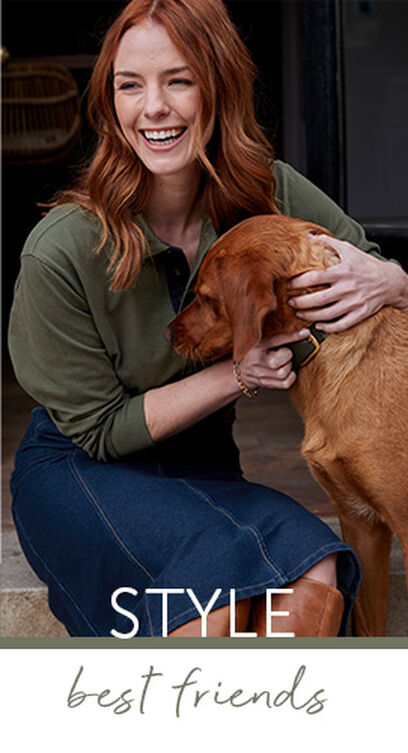 Lady playing with a dog, while wearing a Green Cotton Traders Long Sleeve Polo Shirt and Jersey Denim Midi Skirt