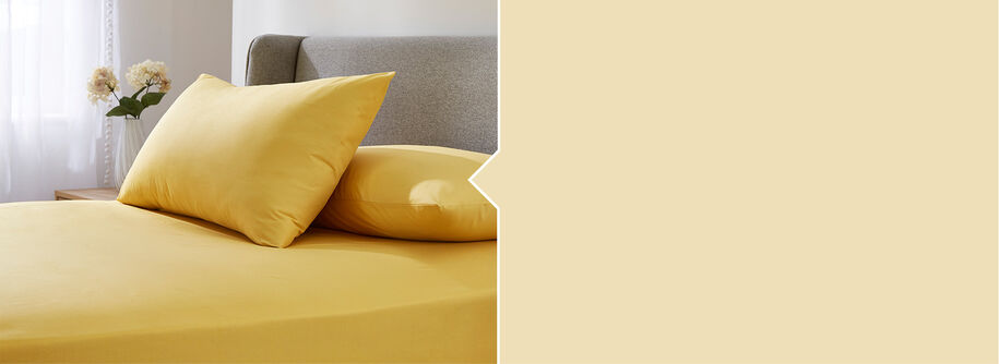 Bedroom style shot of the Cotton traders Easycare Fitted Sheet in Ochre