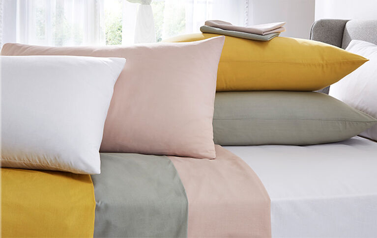 Bedroom styled shot showcasing th different colours offered with the Cotton Traders Easycare Fitted Sheet & Pillowcases