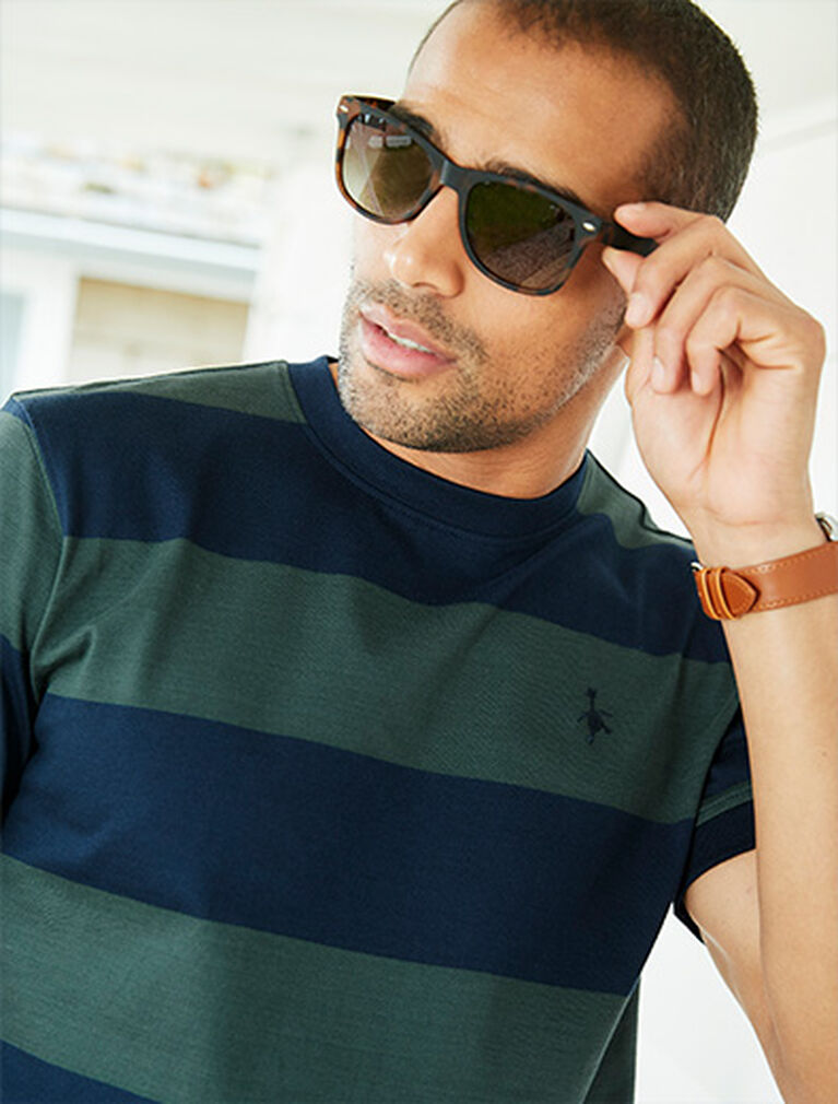 Man wearing sunglasses wearing Cotton Trders green and blue stripe rugby t-shirt