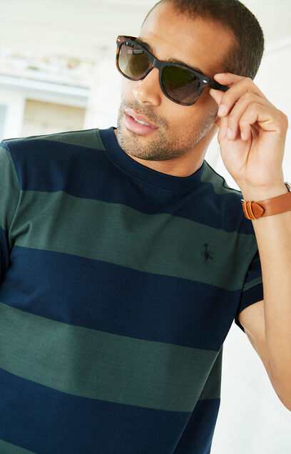 Man wearing sunglasses wearing Cotton Trders green and blue stripe rugby t-shirt