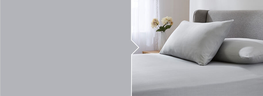 Bedroom style shot of the Cotton traders Easycare Fitted Sheet in Grey