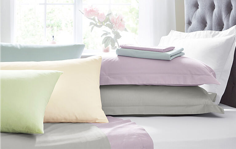 Bedroom styled shot showcasing th different colours offered with the Cotton Traders Cotton Percale Flat Sheet & Pillowcases