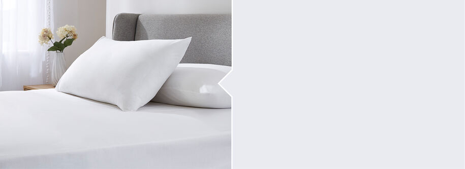 Bedroom style shot of the Cotton traders Easycare Fitted Sheet in White