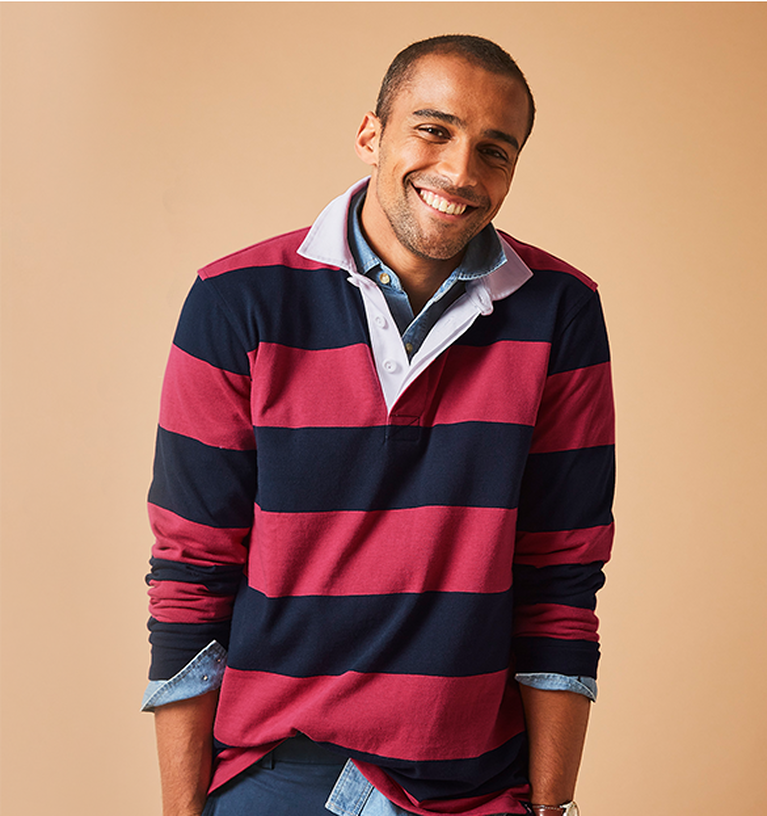 Man smiling whilst wearing a striped rugby shirt